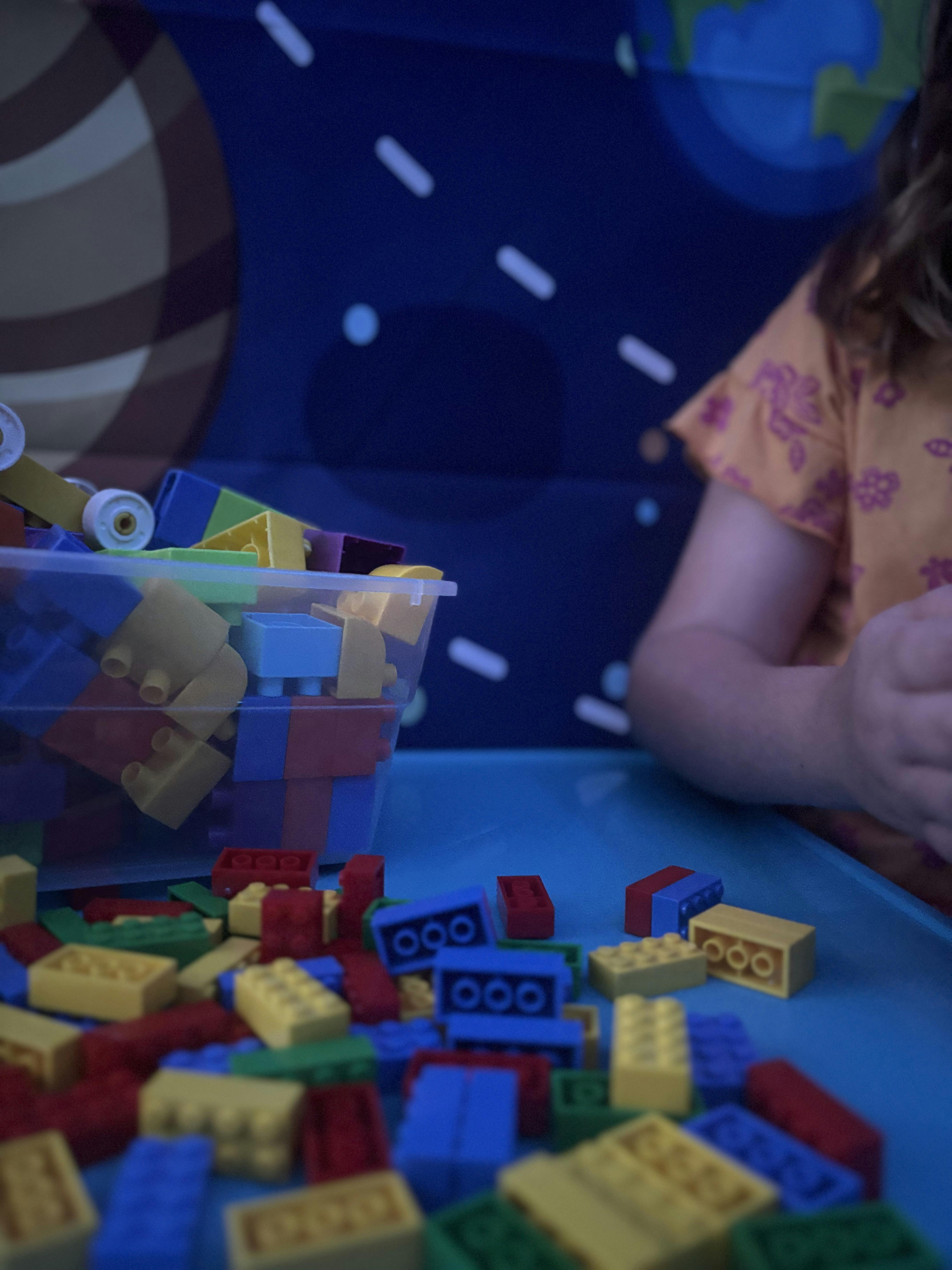 Child playing with colorful building blocks