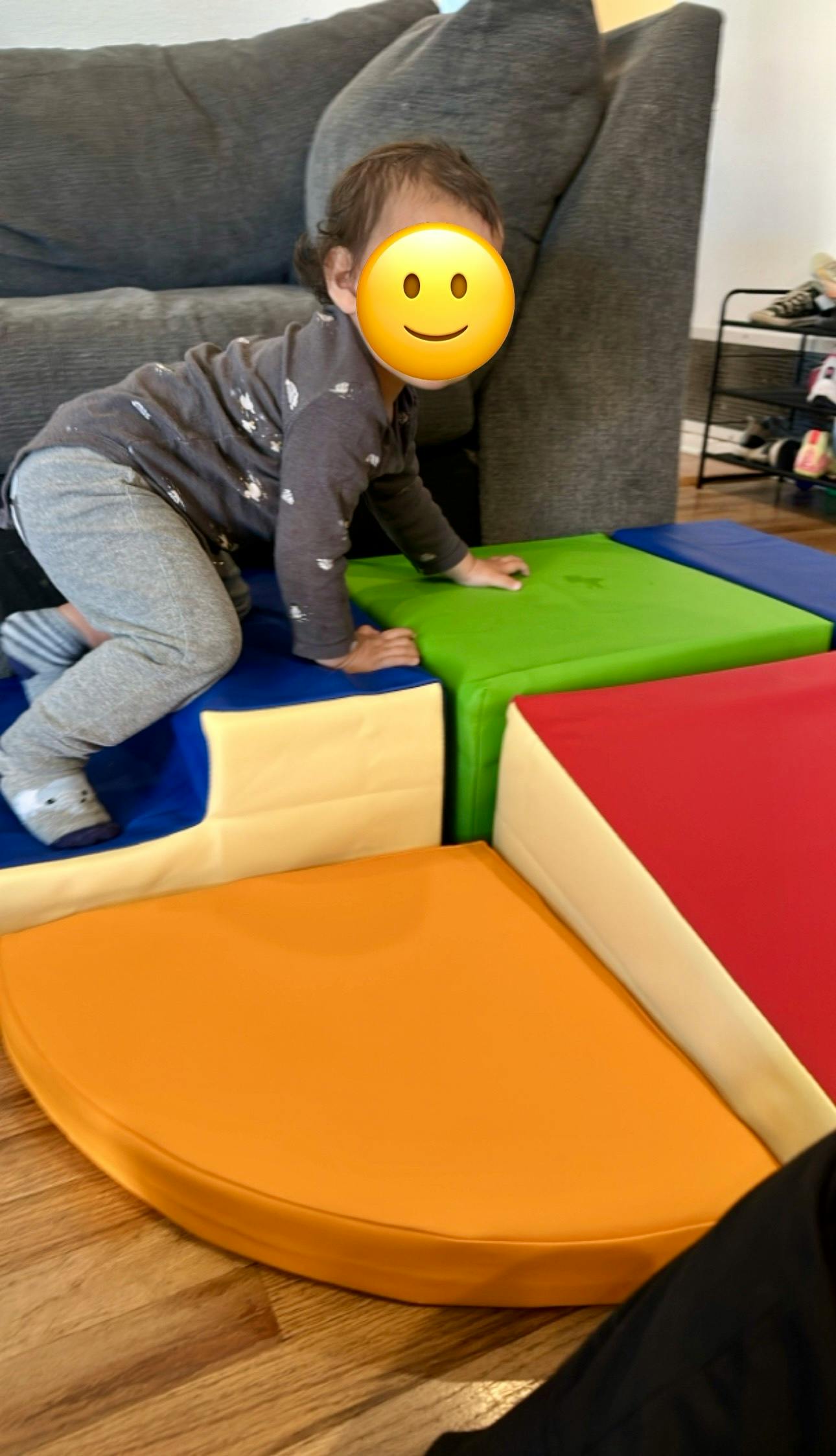 Child crawling on colorful soft play blocks