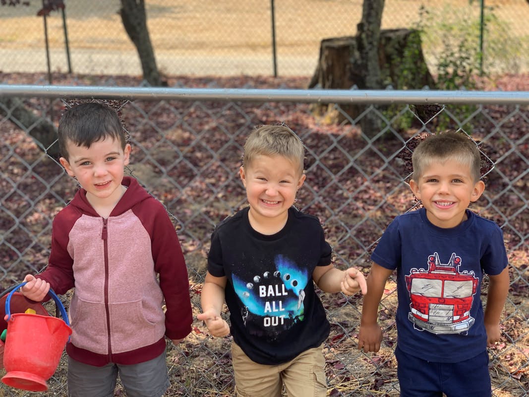 Three children standing outdoors