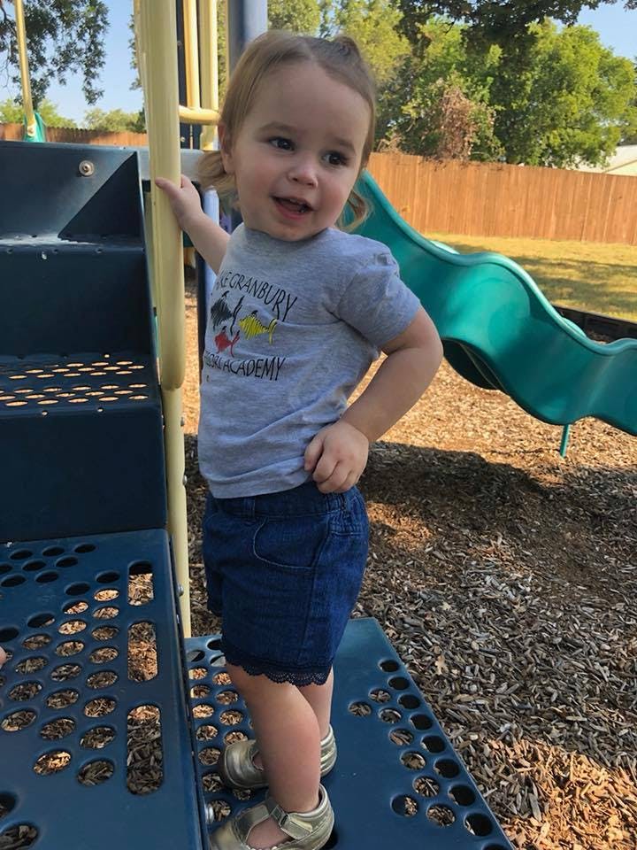Child standing on playground equipment