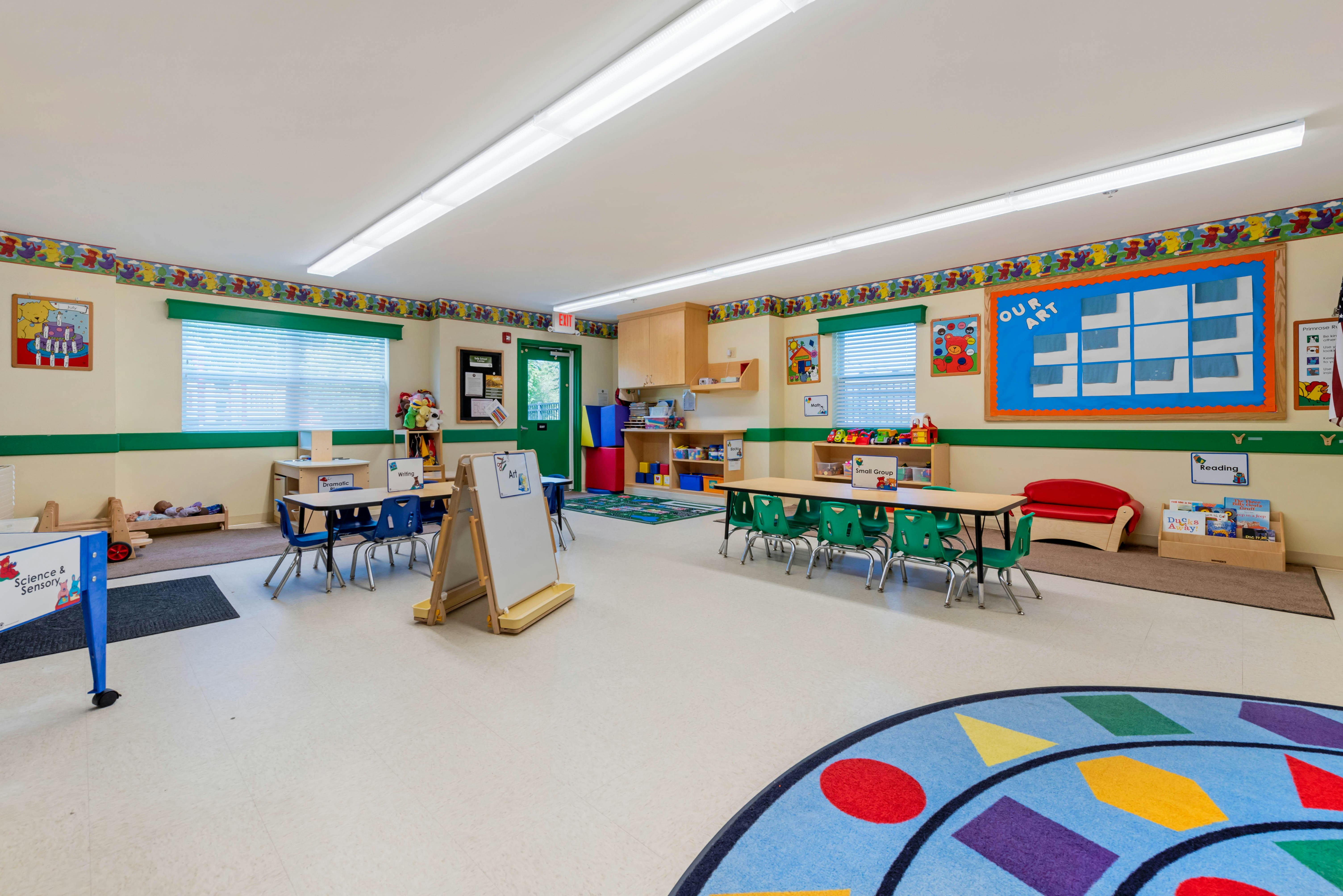 Empty classroom with small tables and chairs