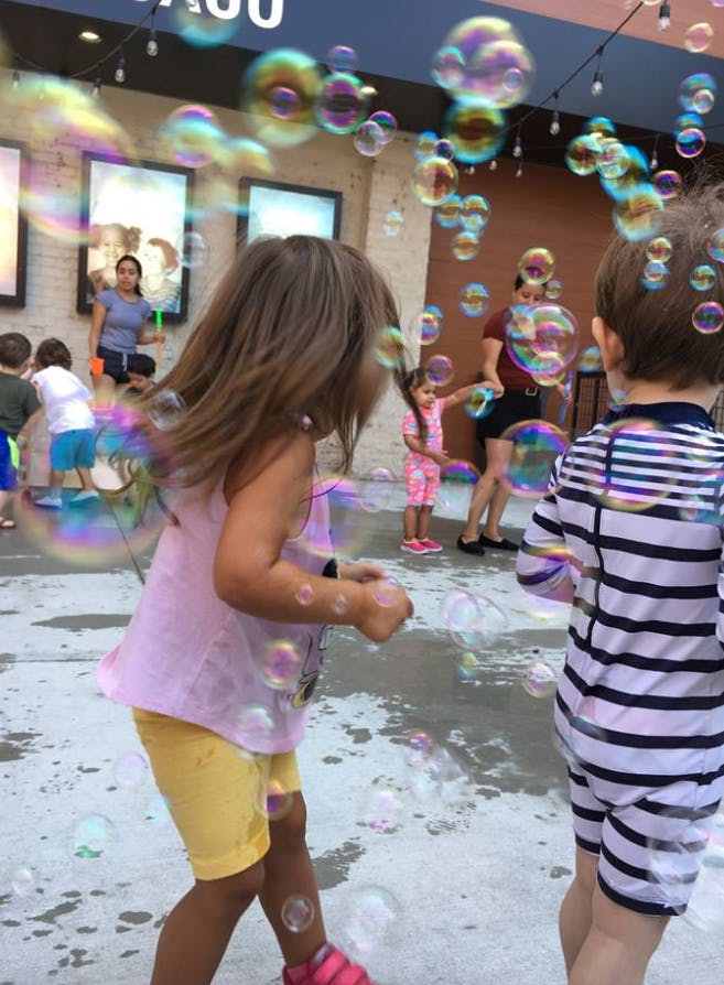 Children playing with bubbles outdoors