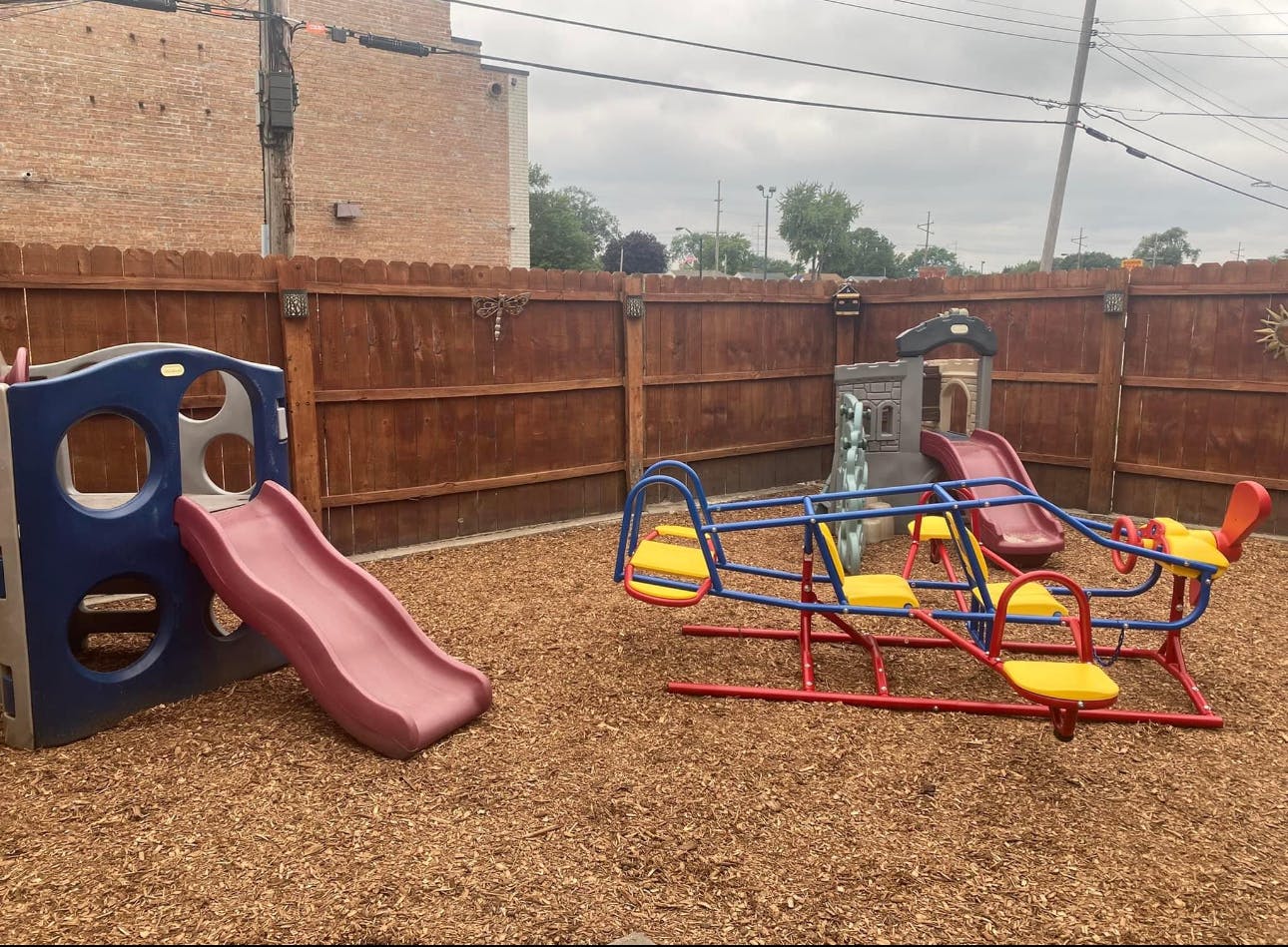 Playground with a slide and a multi-person seesaw