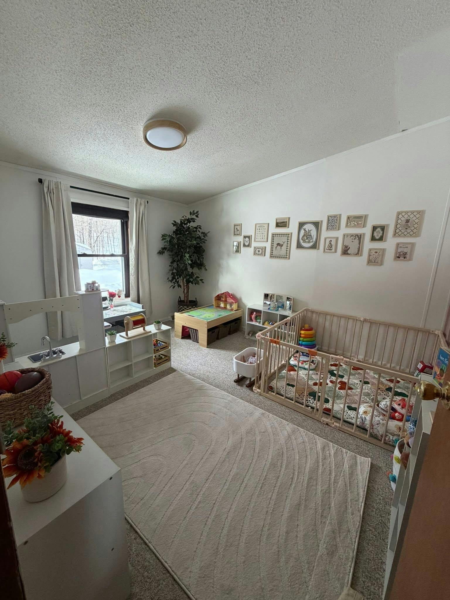 Child playroom with toys, a wooden playpen, and a rug