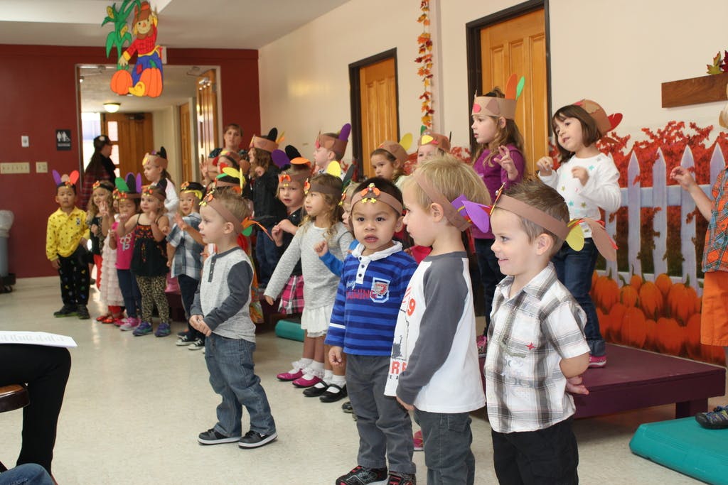 Group of children standing in a line indoors