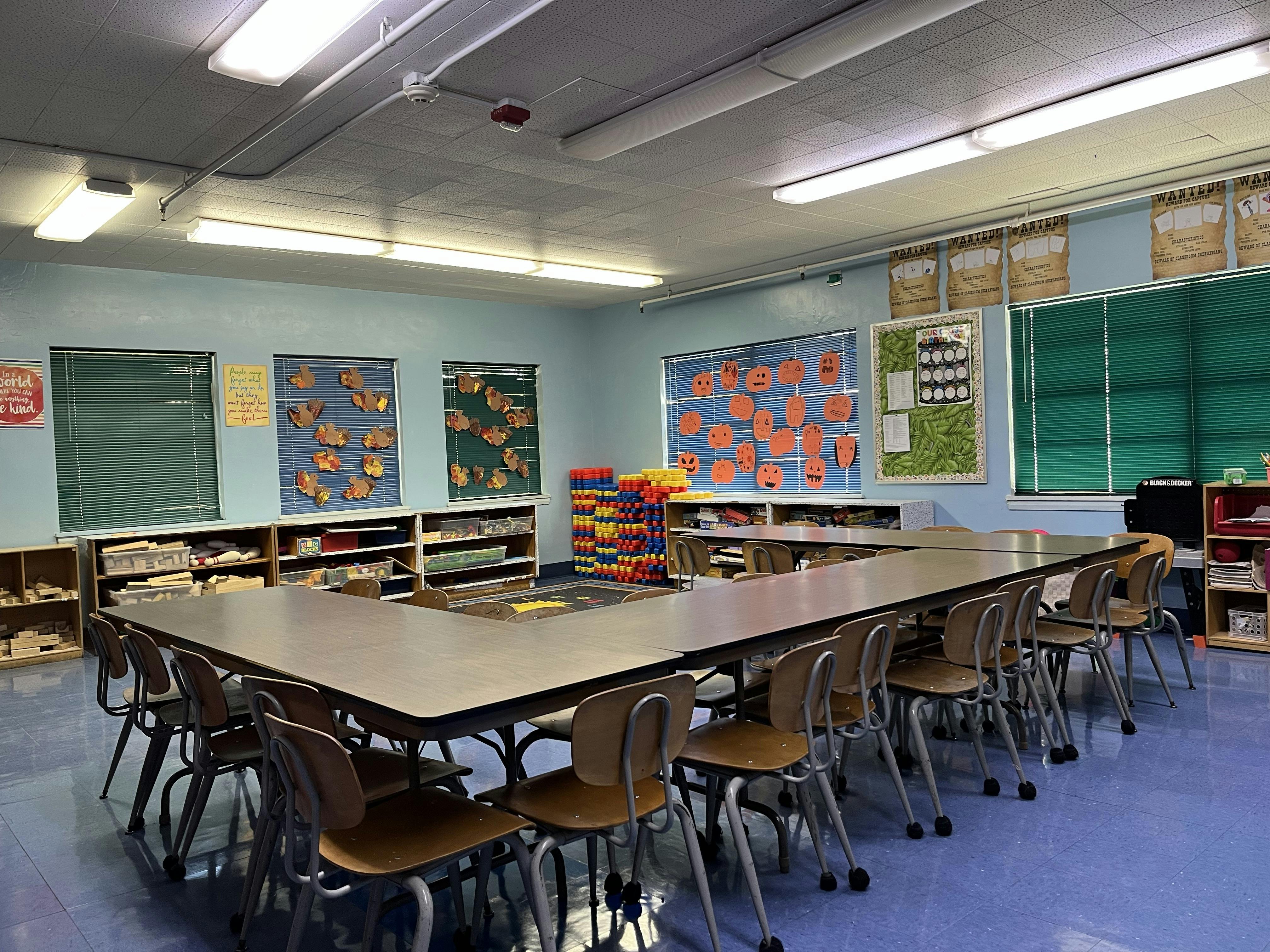 Empty classroom with U-shaped table and chairs