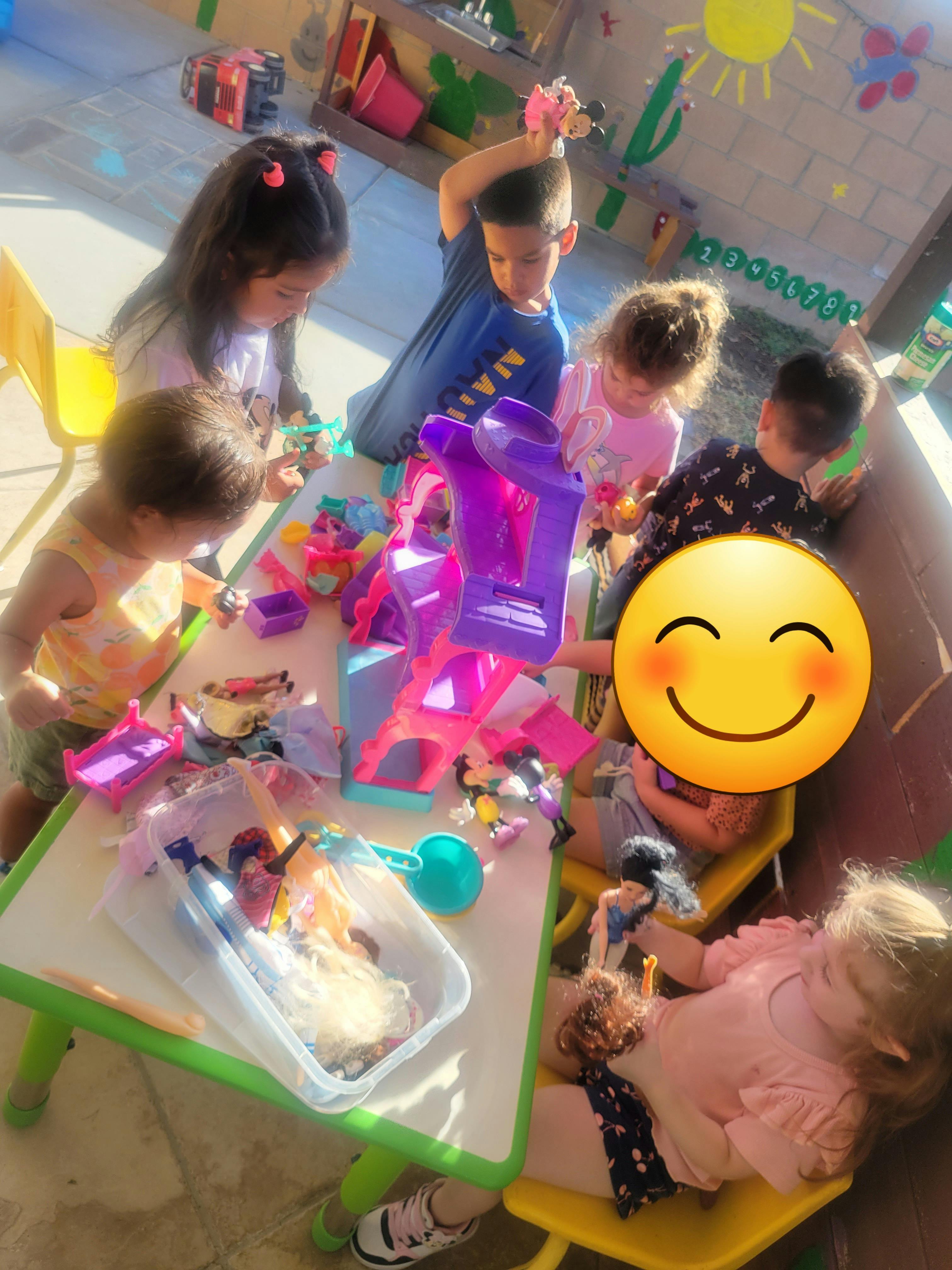 Children playing with toys at a table
