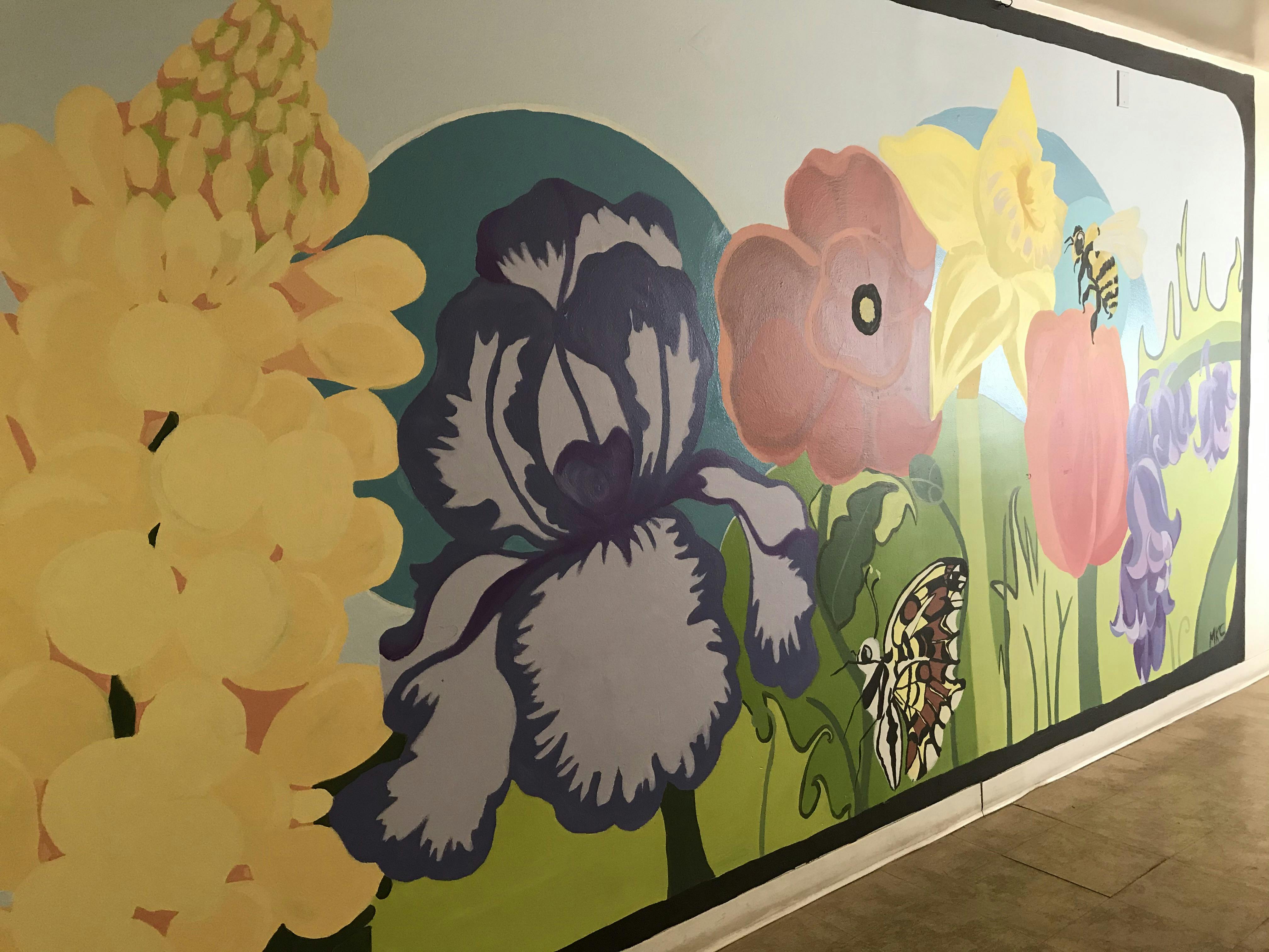 Mural of various flowers including irises, poppies, and daffodils