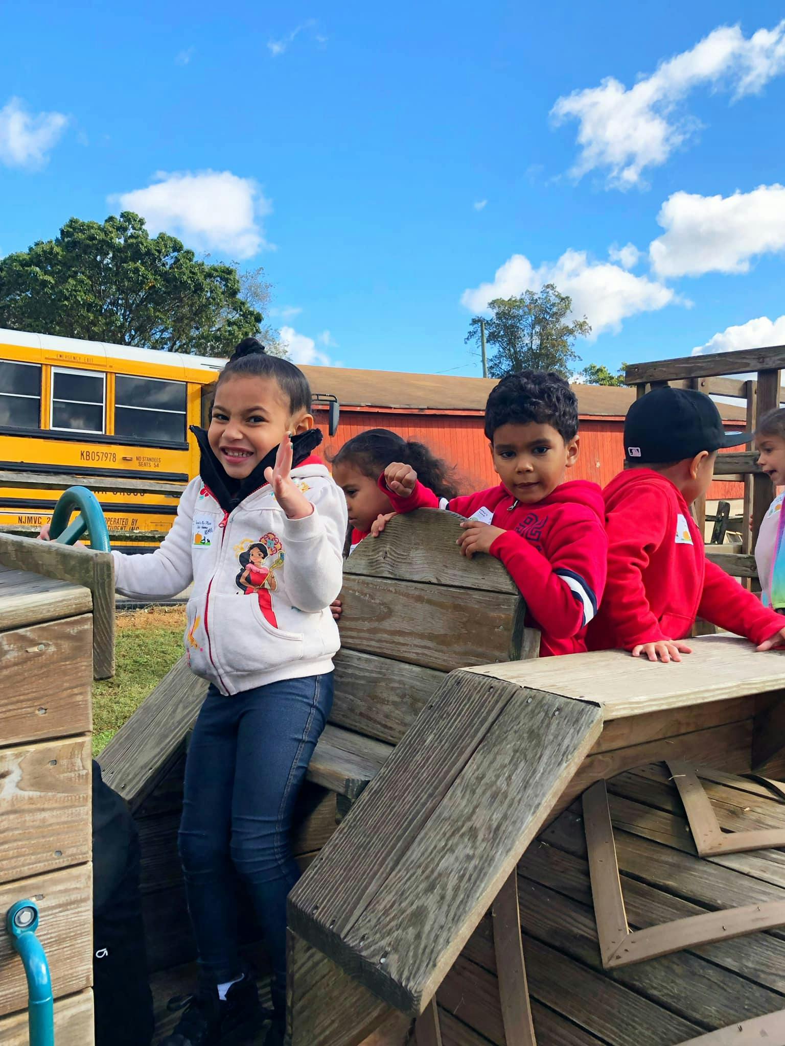 Children playing on a wooden structure outdoors