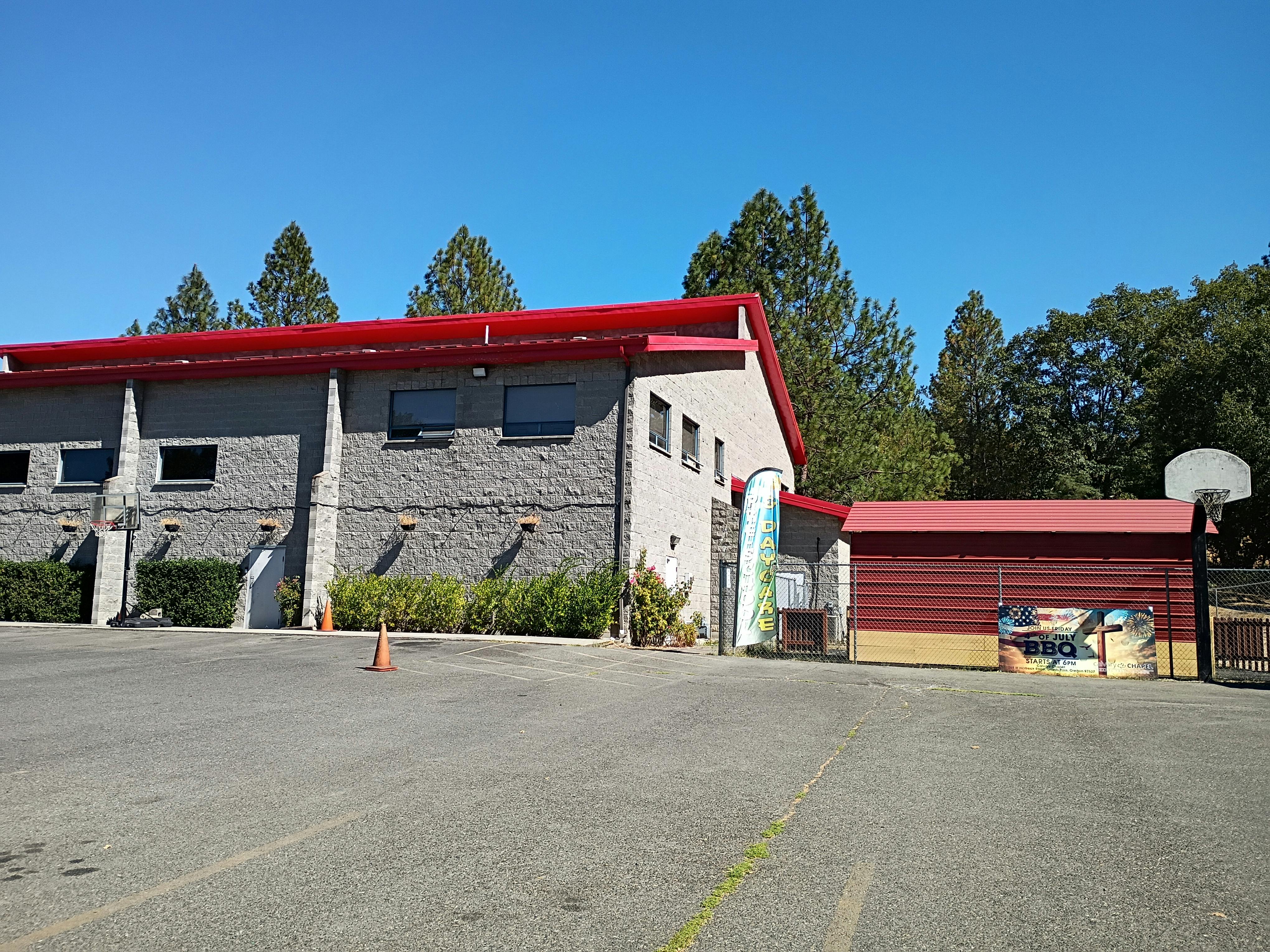 Building with red roof next to a basketball hoop