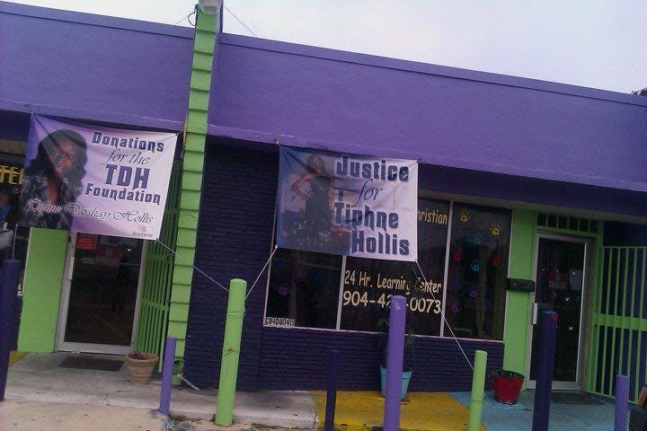 Building with banners that read "Donations for the TDH Foundation" and "Justice for Tiphnae Hollis"