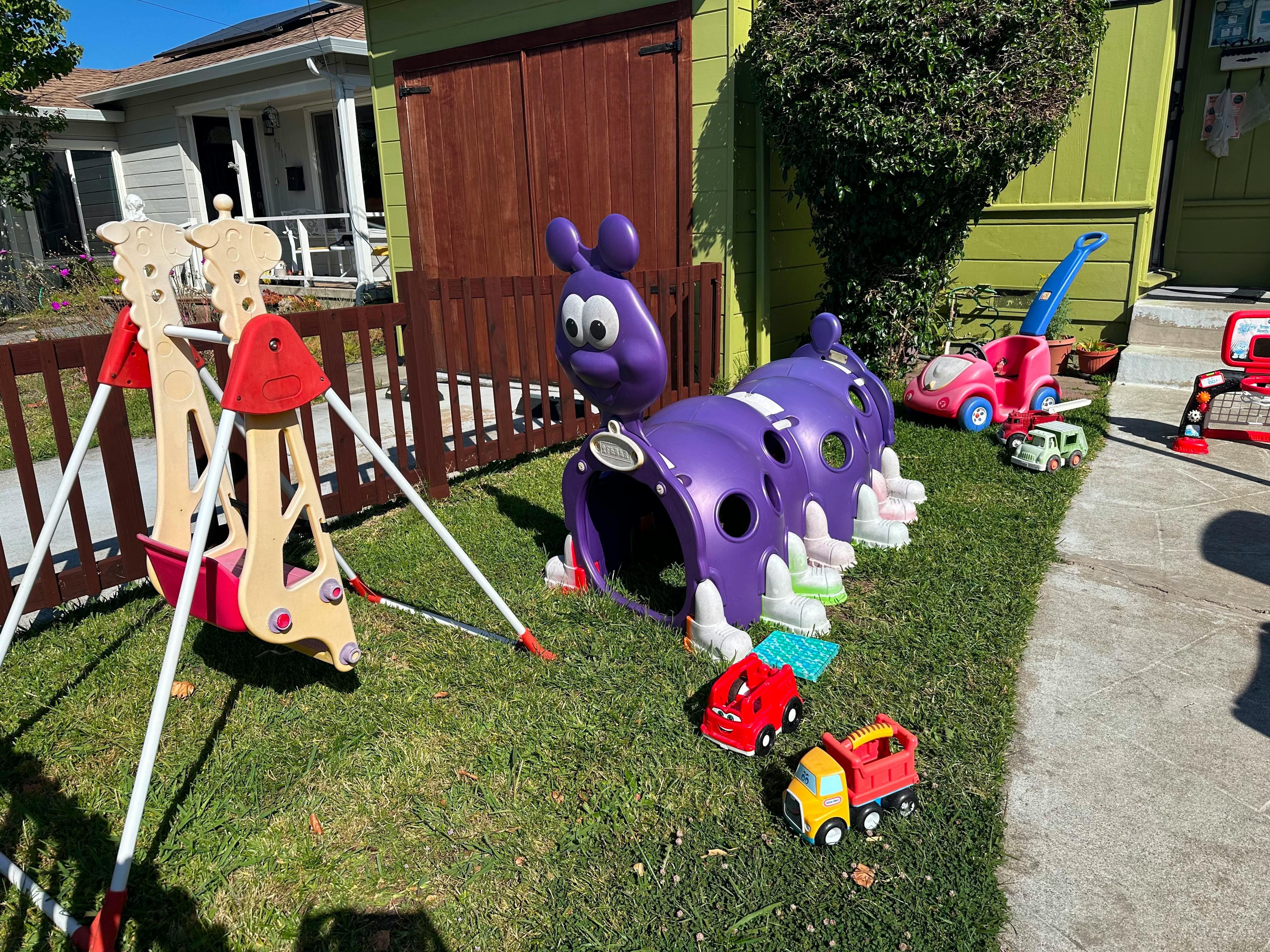 Plastic children play equipment including a caterpillar tunnel and swing set