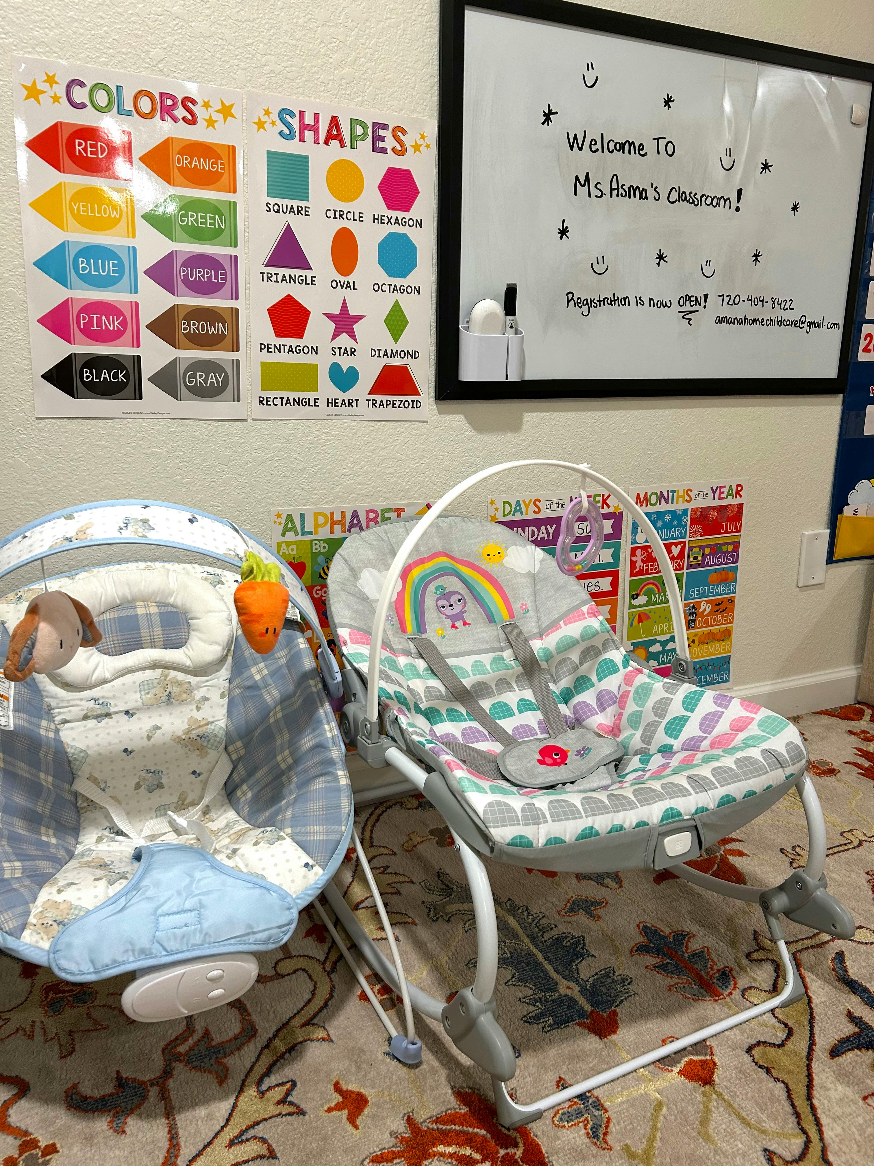 Two baby bouncers in a classroom with educational wall charts
