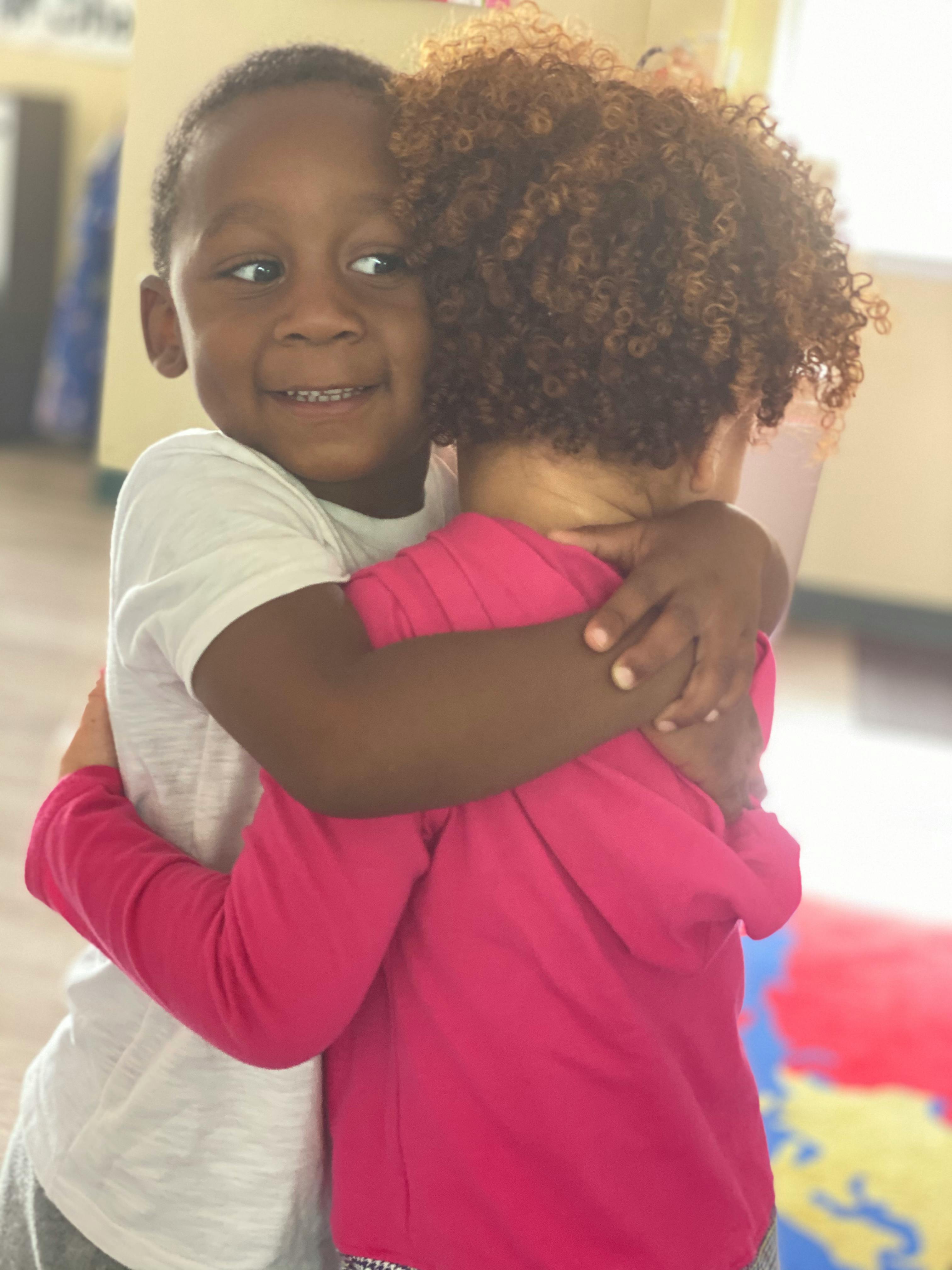 Two children hugging