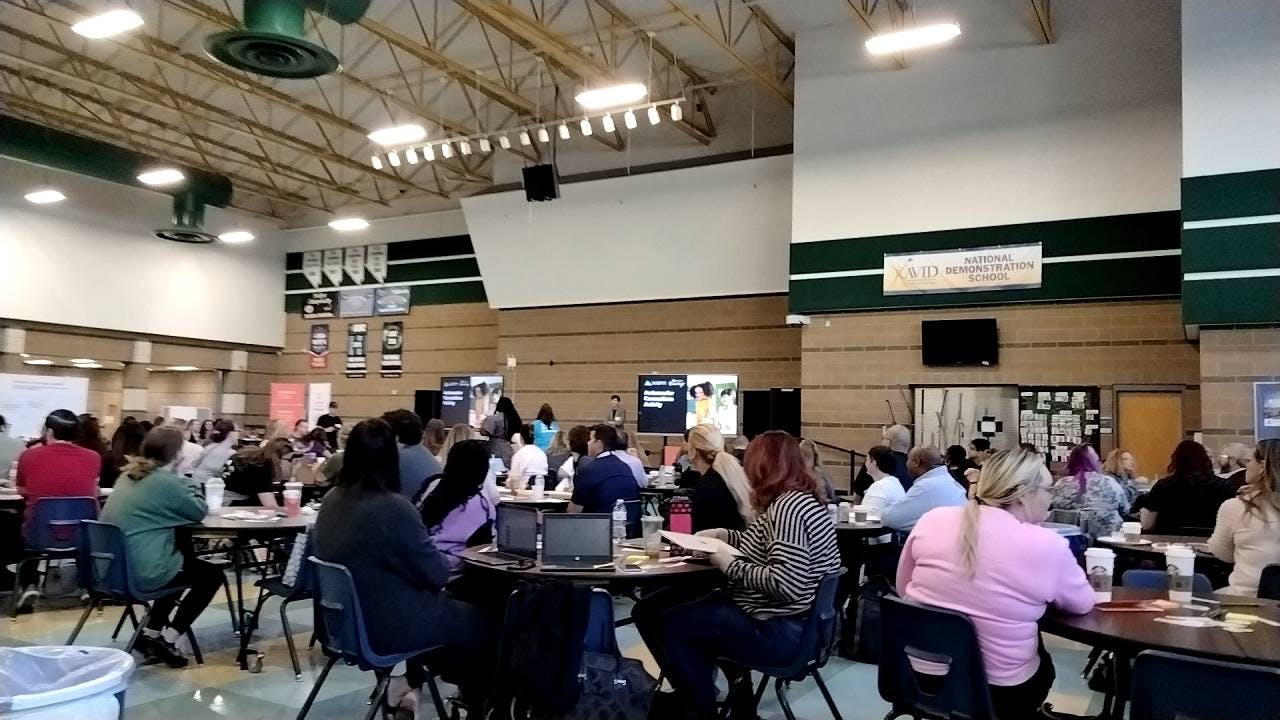 People sitting at tables in a large room