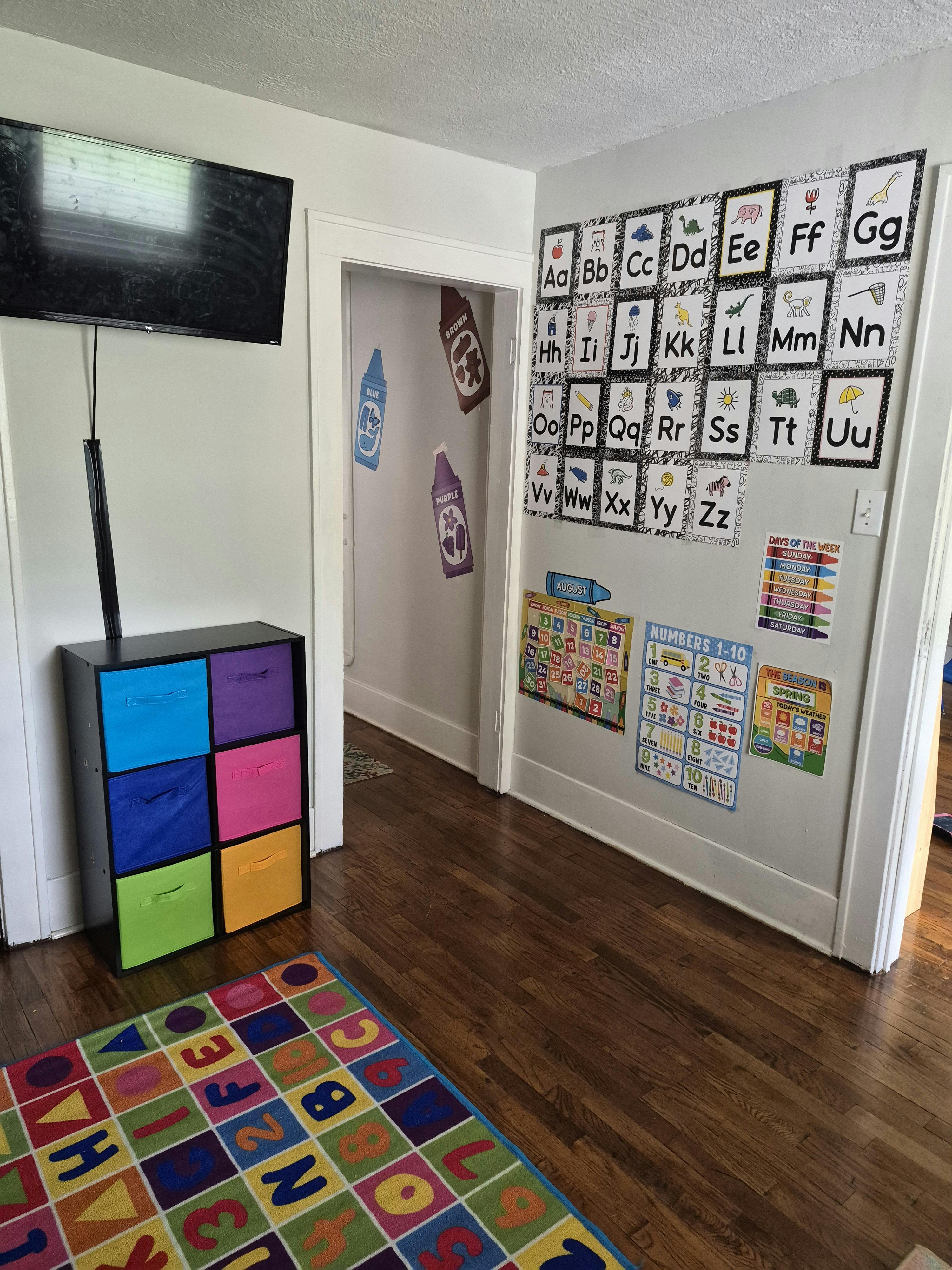 Educational wall charts and a colorful storage unit in a room