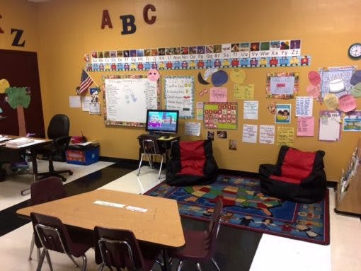 Classroom with ABCs on the wall, small tables and chairs, and beanbag chairs