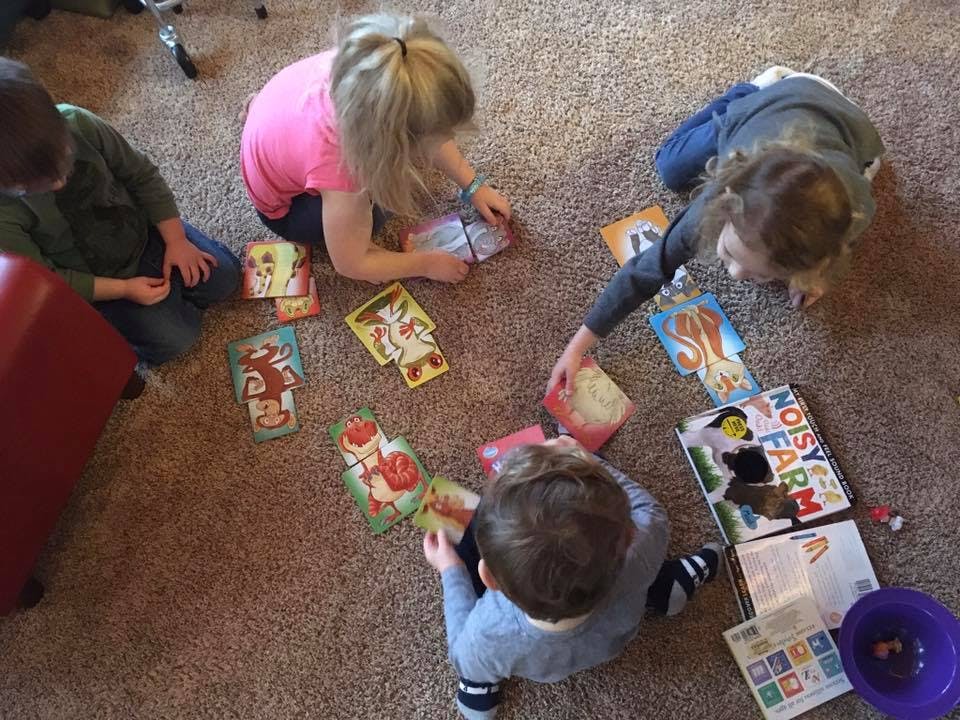 Children playing a board game on the floor