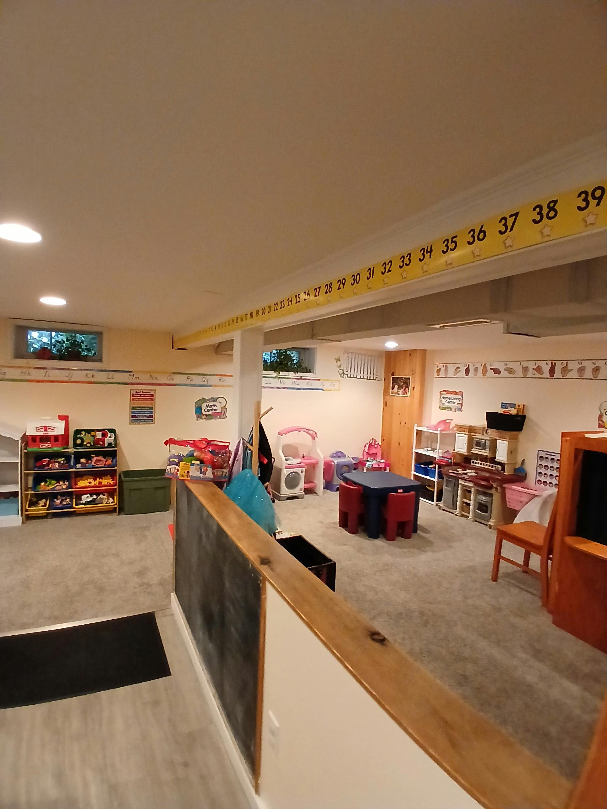 Playroom with toys, small tables, and chairs