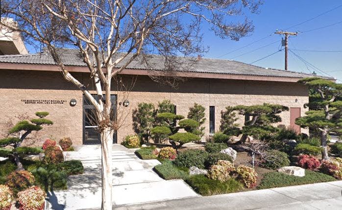 Building with a landscaped garden and manicured garden in front