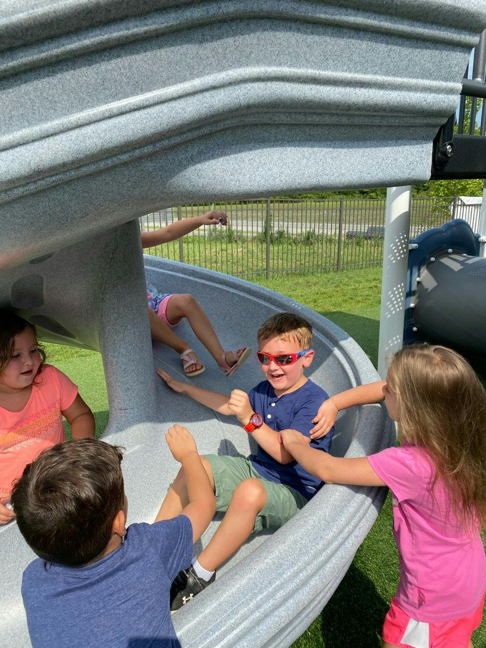Children playing on a playground slide