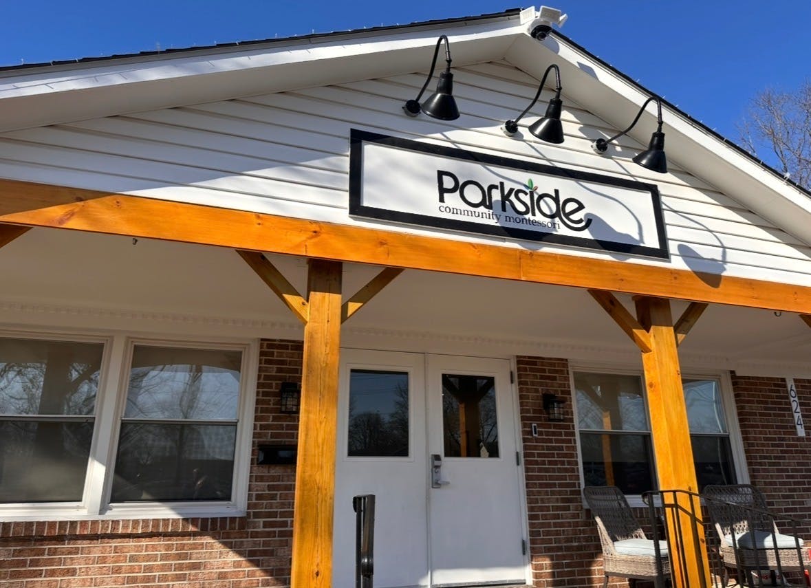 Parkside community montessori sign on a building with a porch