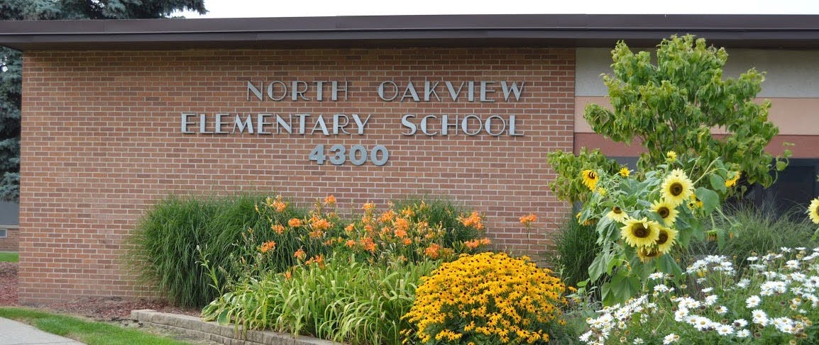 North Calview Elementary School sign on a brick building with flowers