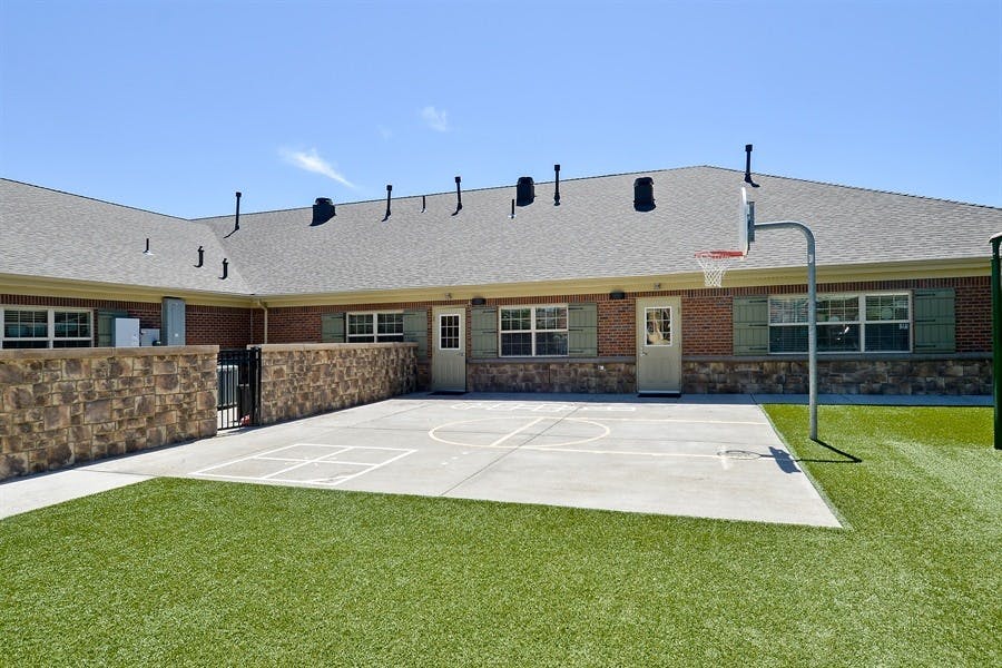 Outdoor basketball court with a hoop next to a building