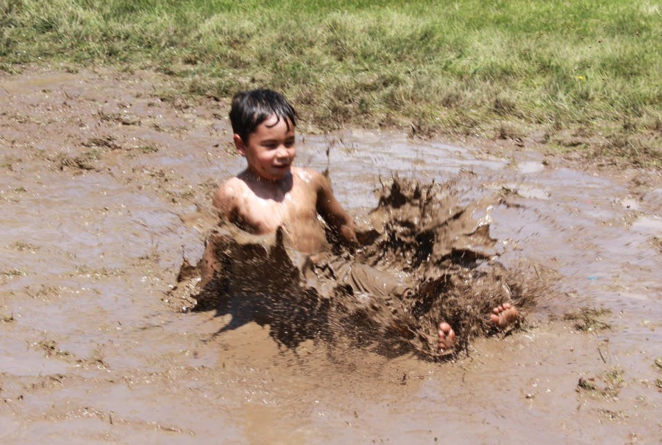 Child splashing in mud