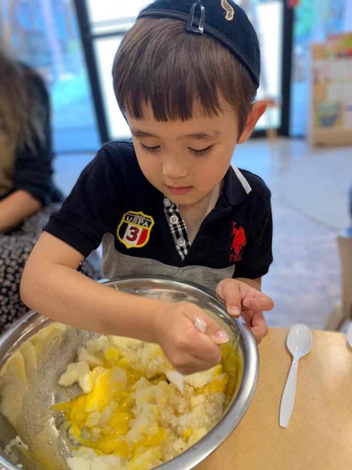 Child mixing ingredients in a bowl