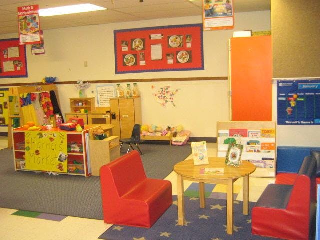 Classroom with a play farmer's market, small tables, and chairs