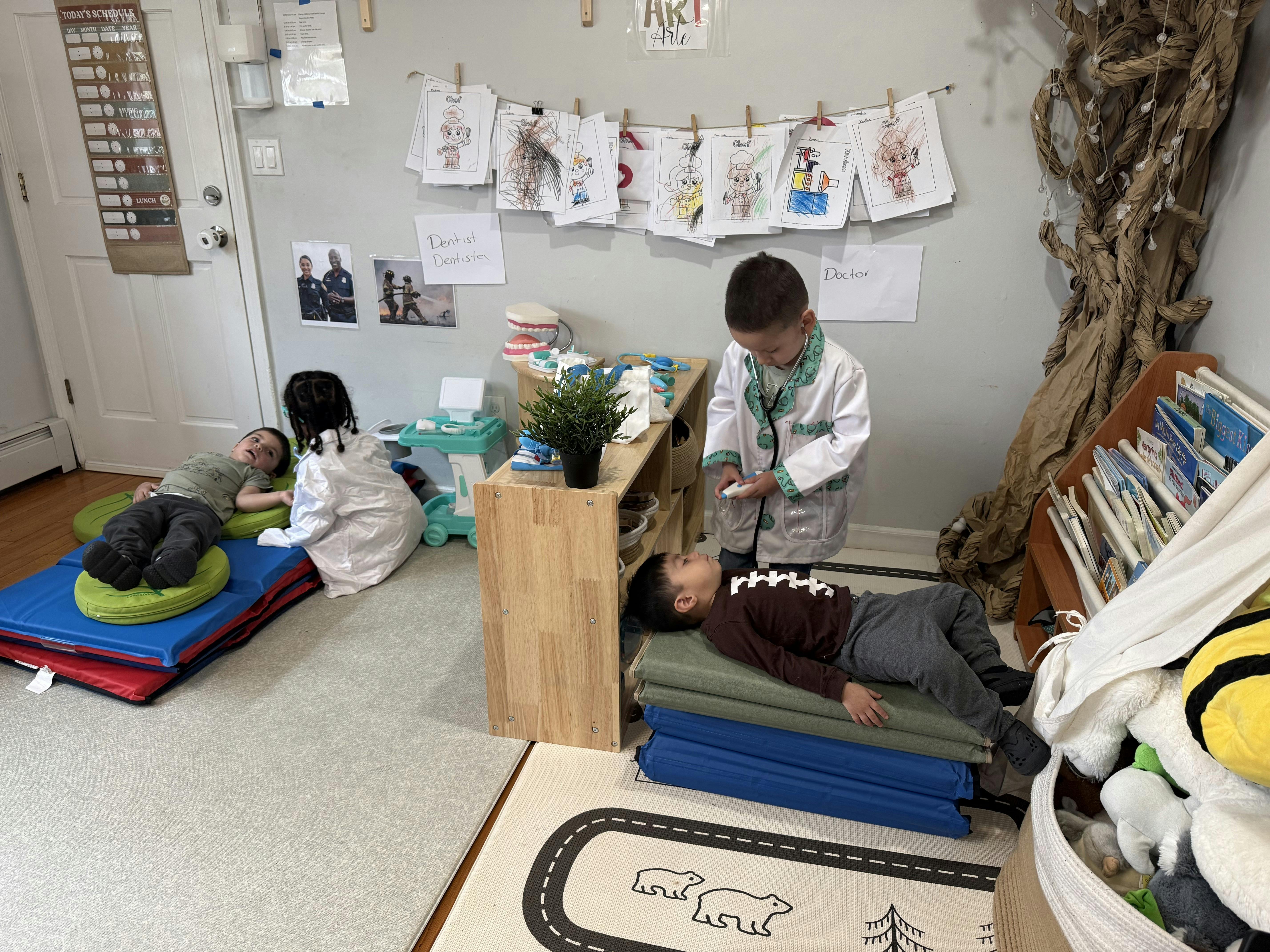 Children roleplaying as doctors and patients in a classroom
