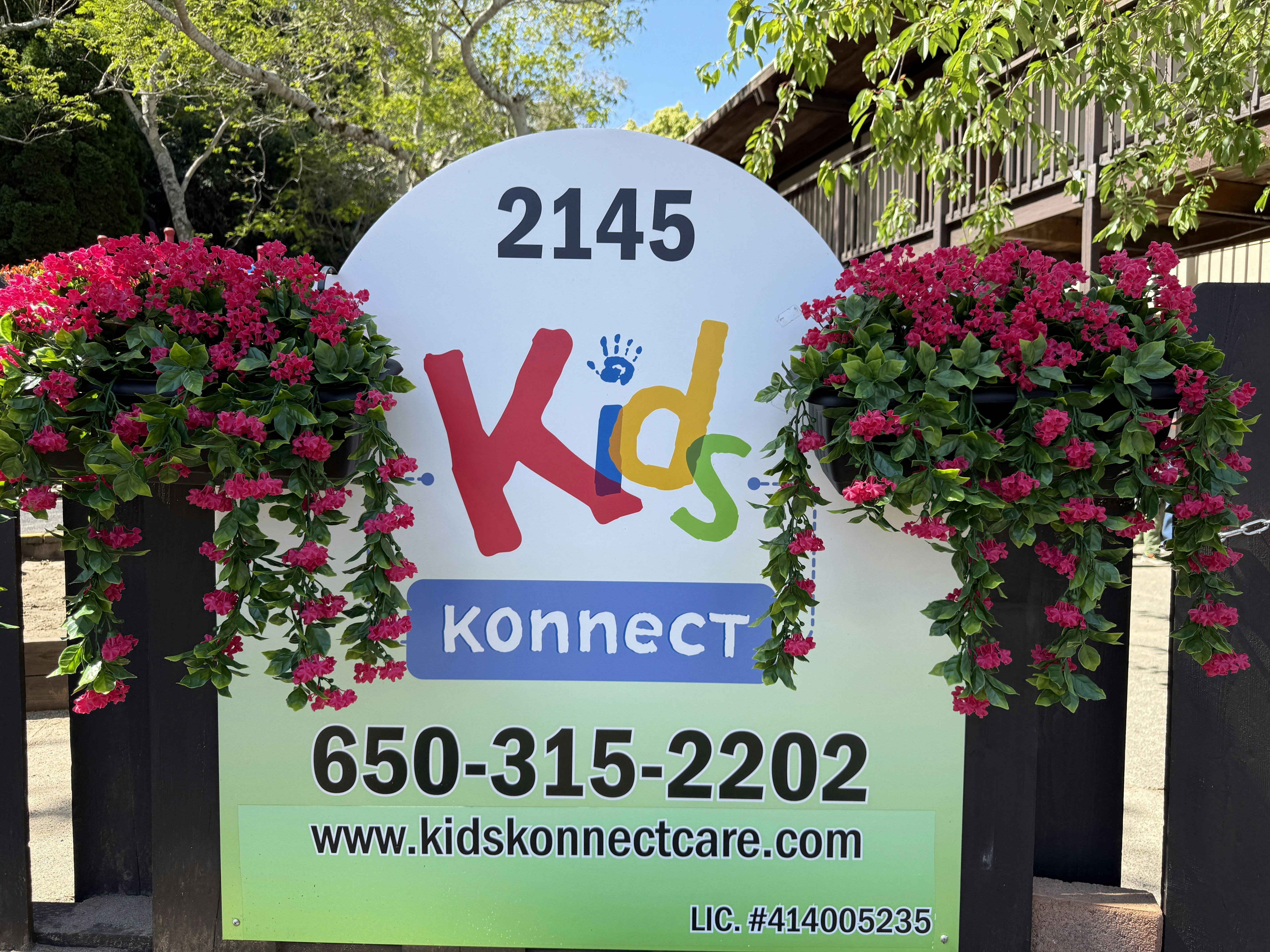 Sign for Kids Konnect daycare with address, phone, and website