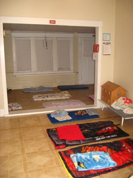 Sleeping bags and mats on a floor in a room