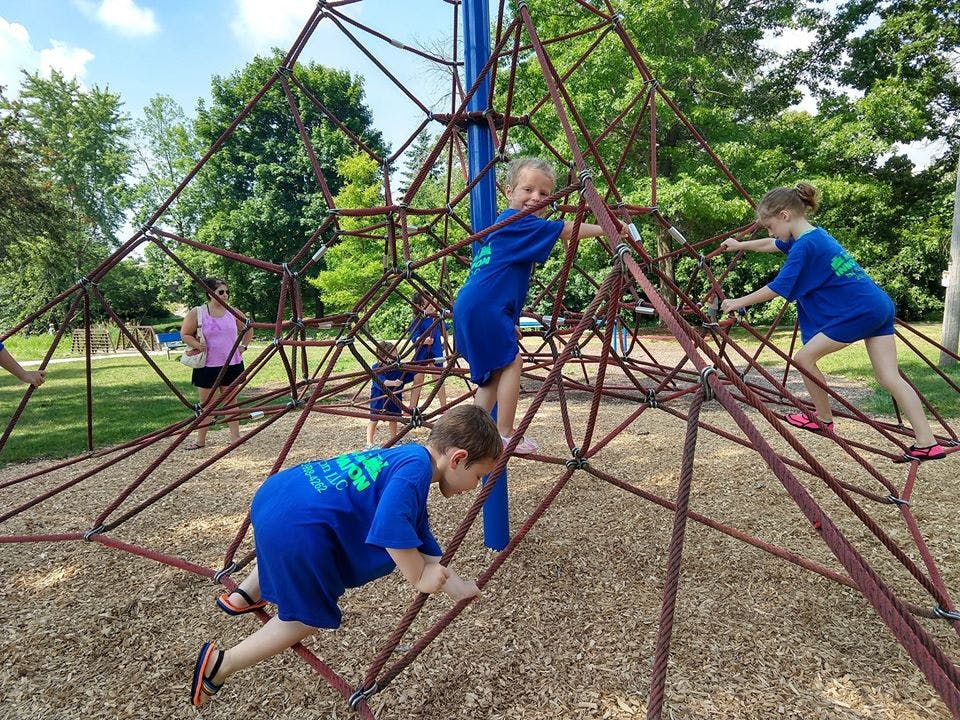 Children climbing on a rope structure at a playground
