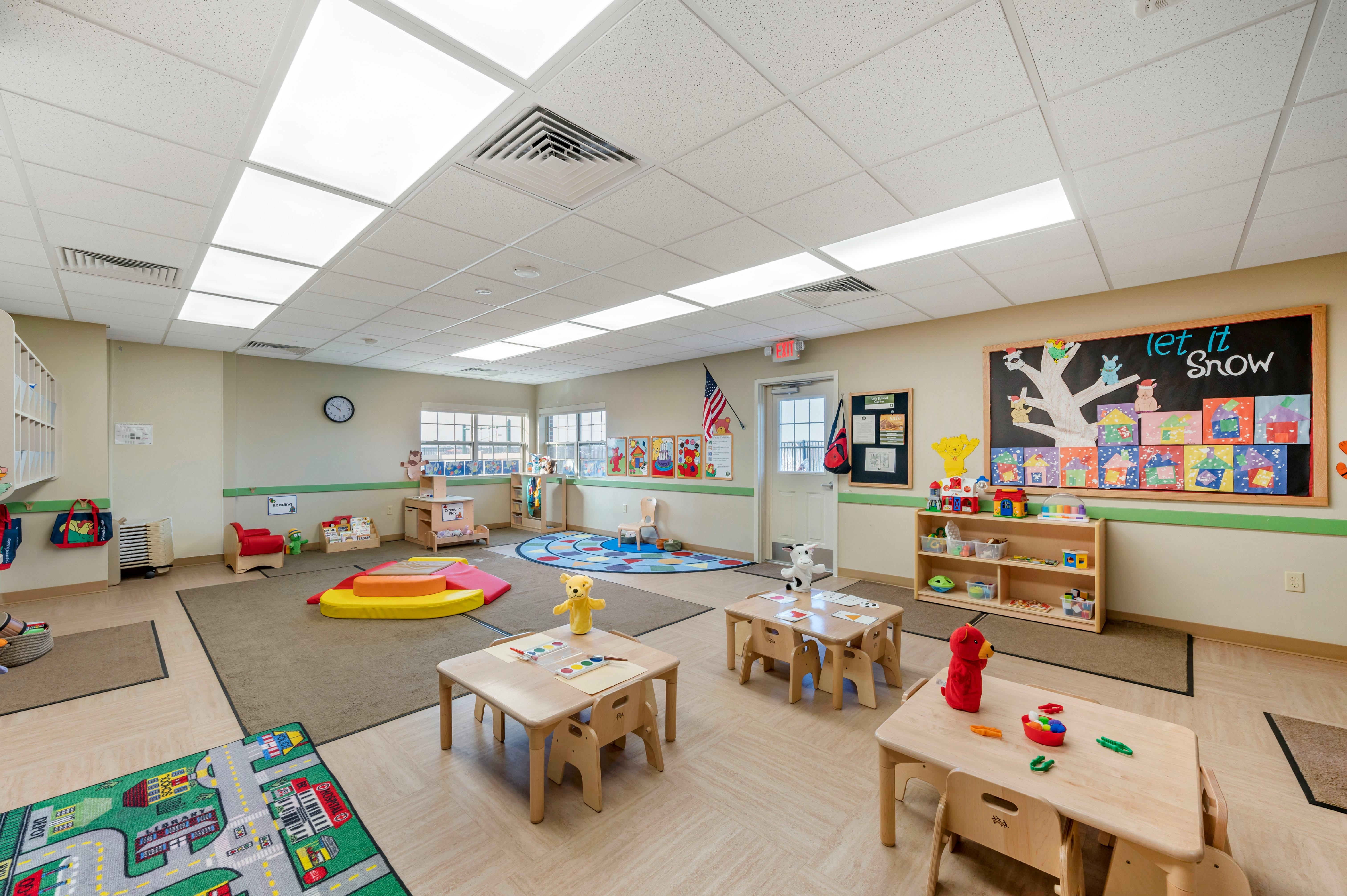 A colorful and well-lit classroom filled with children's toys and furniture