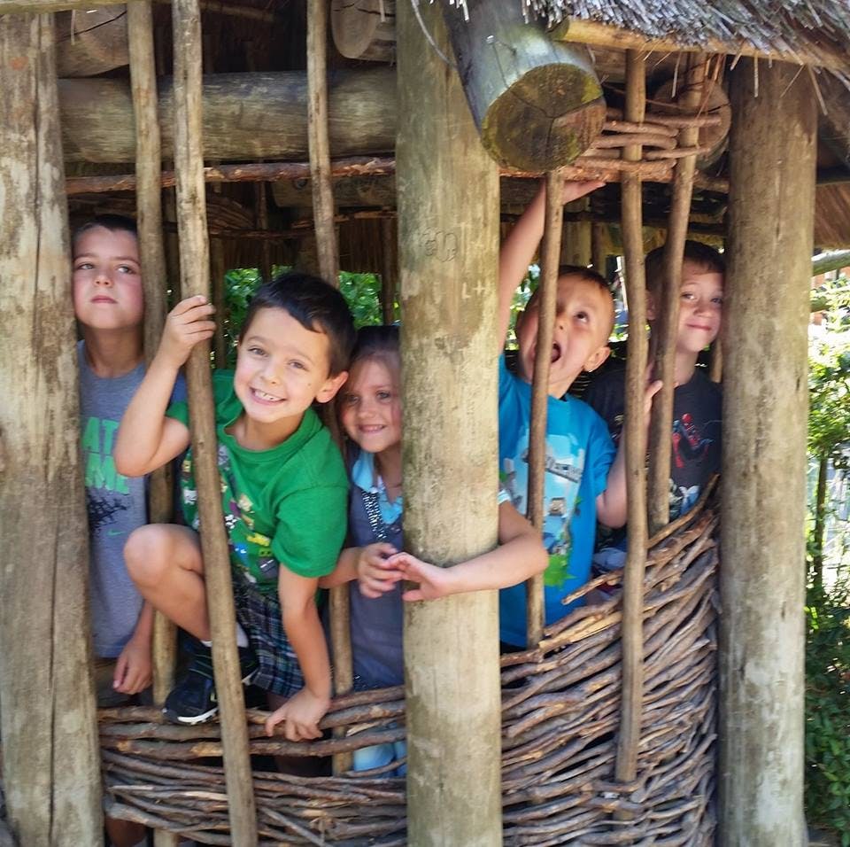Children playing in a wooden structure
