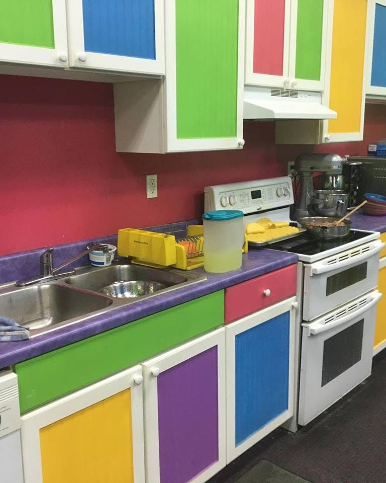 Kitchen with colorful cabinets and appliances