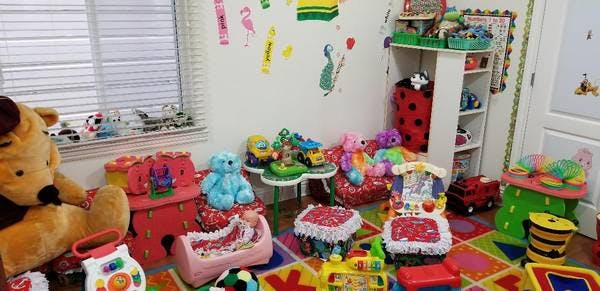 A room filled with various toys, including stuffed animals and play furniture