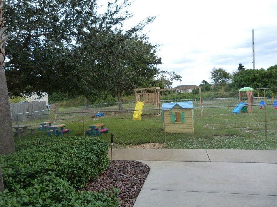 Outdoor playground with slides, swings, and playhouses