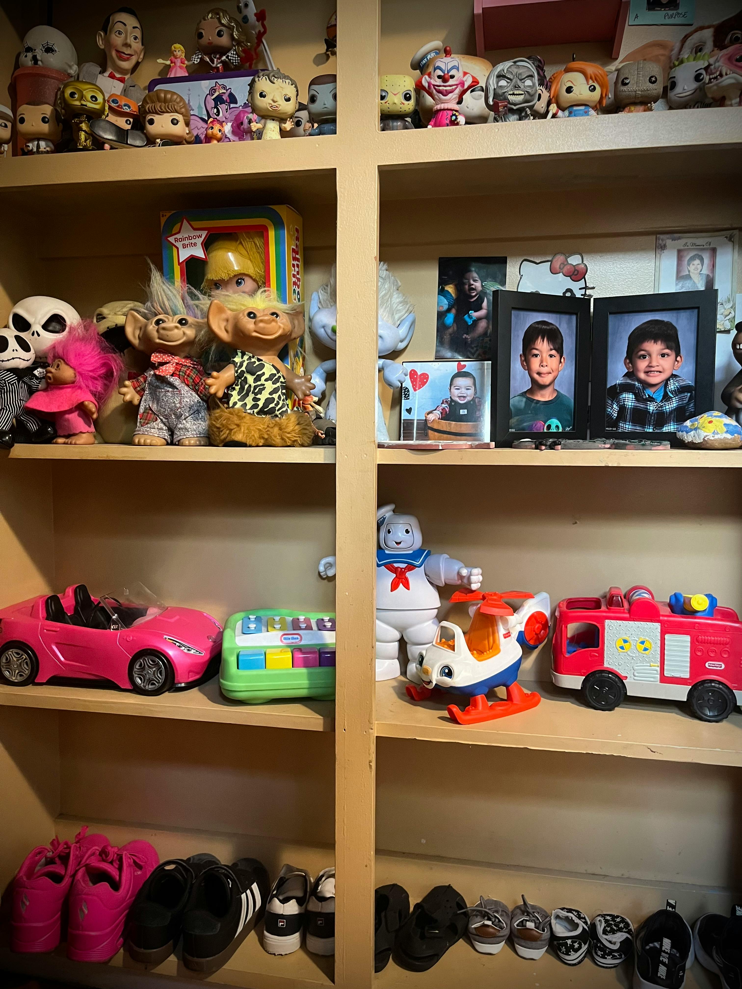 Shelves filled with toys, framed photos, and shoes