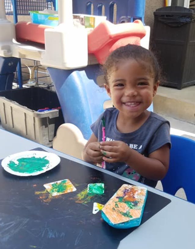 Child painting at a table