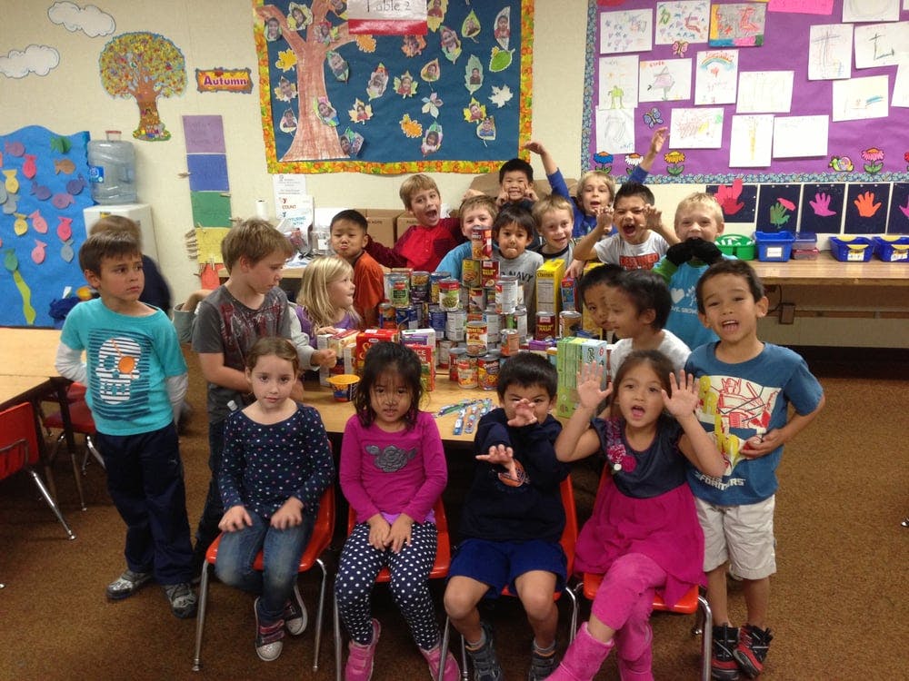 Group of children posing in a classroom