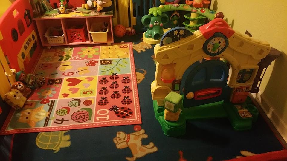 Playroom with colorful rug and children's toys