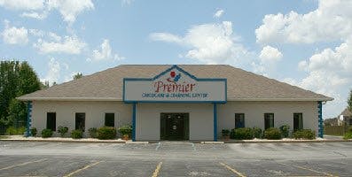 Building with "Premier" sign and parking lot
