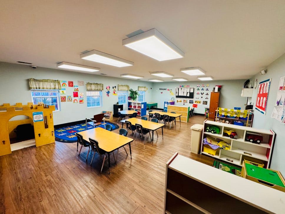 Empty colorful children's classroom with small tables and chairs