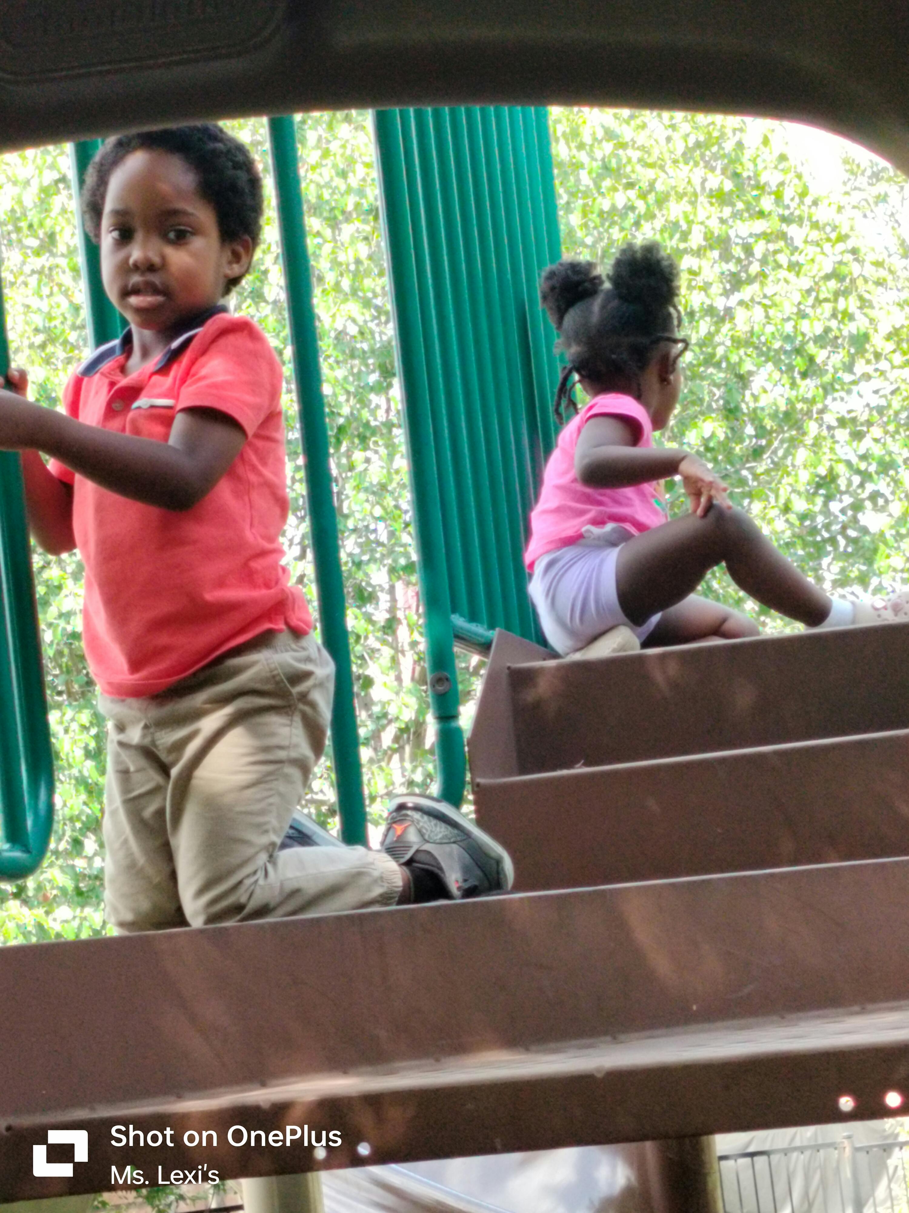 Two children on playground equipment