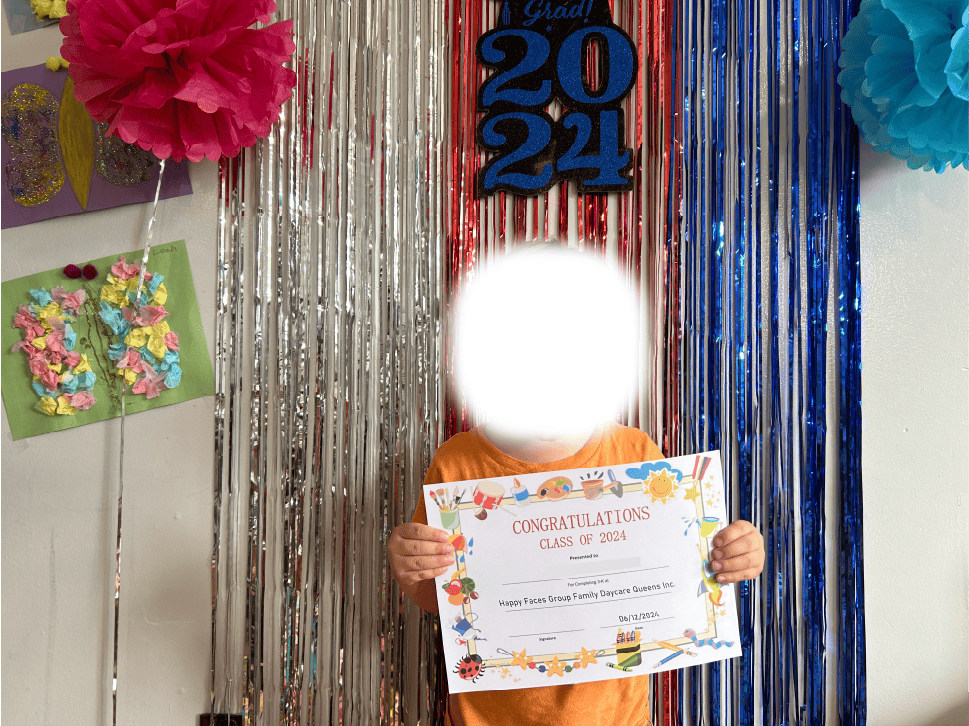 Child holding a certificate in front of a festive backdrop