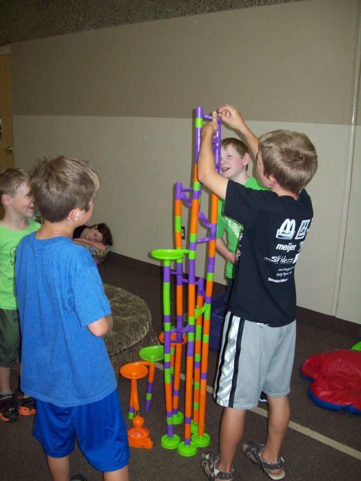 Children building a colorful marble run toy