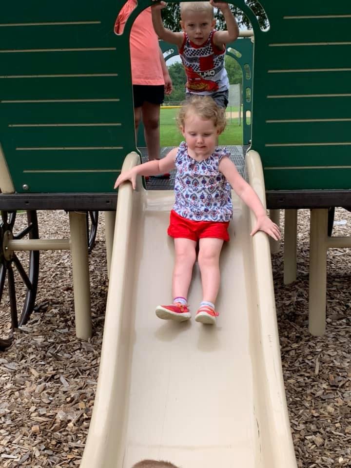 Child sliding down a playground slide